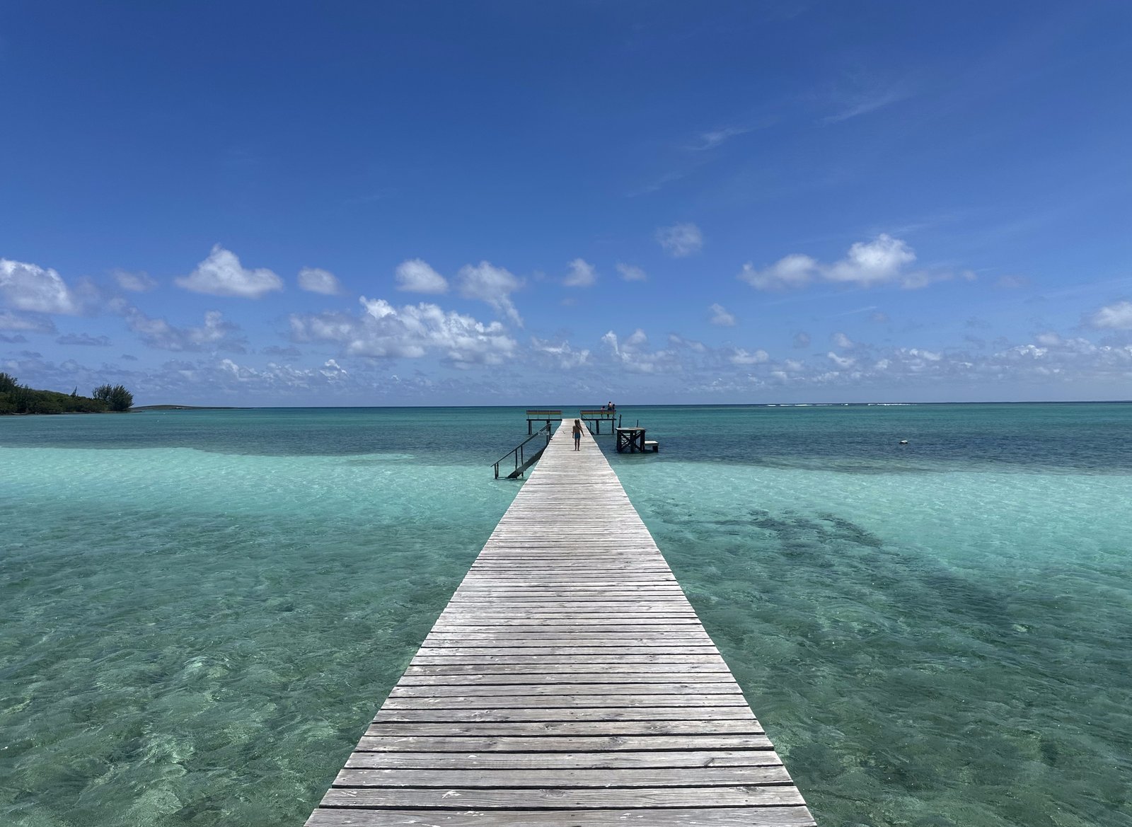 A view straight down Cherokee Sound's Long Dock, over clear turquoise water