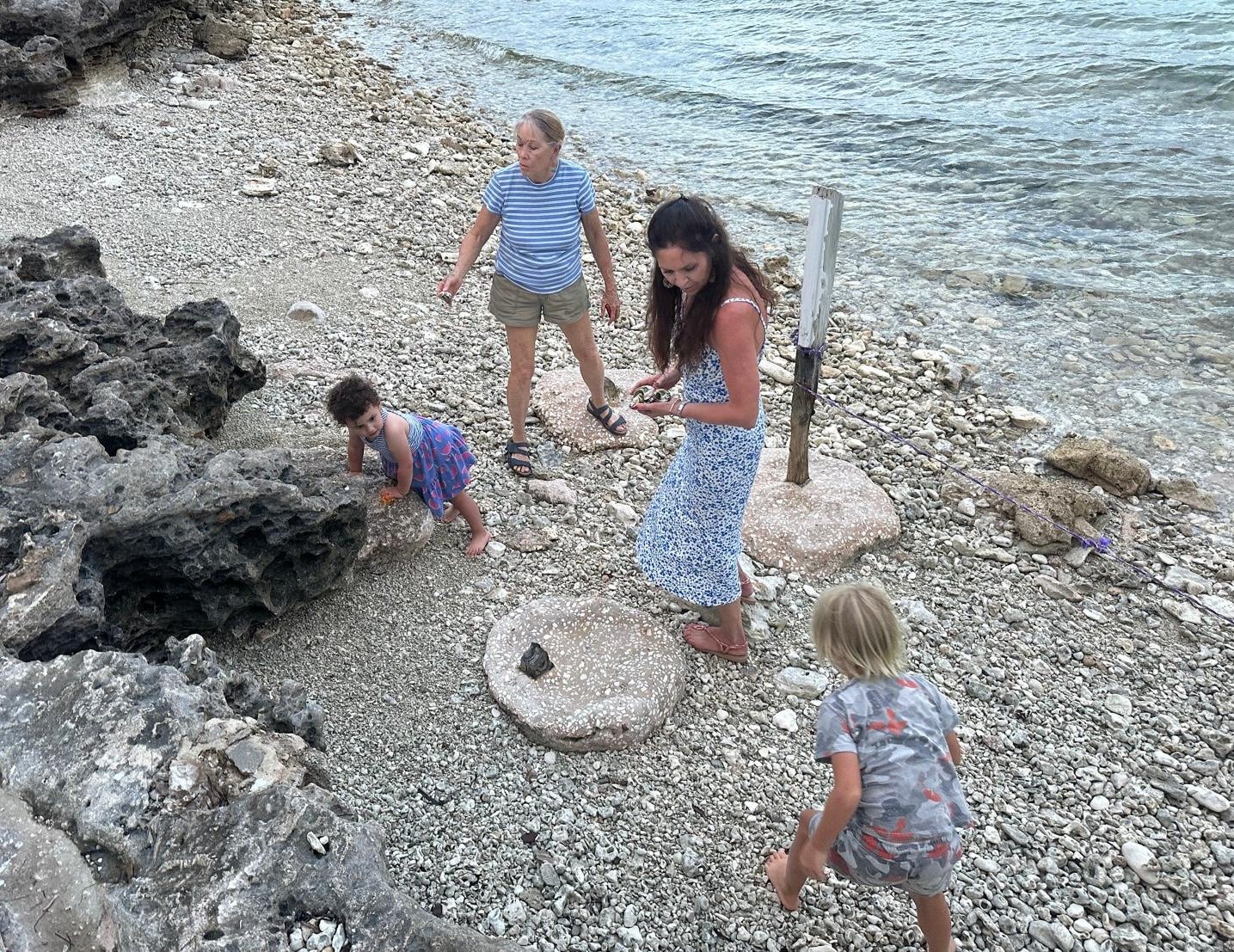 Collecting shells and sea glass with family