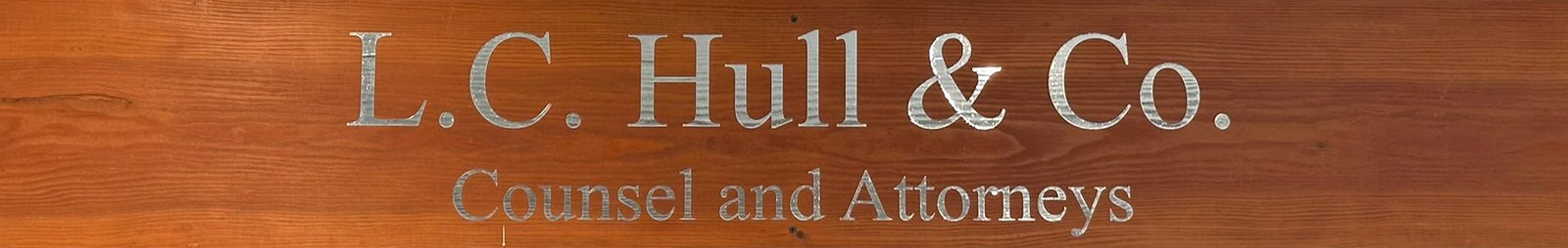 A wooden sign reading L.C. Hull and Co., Counsel and Attorneys