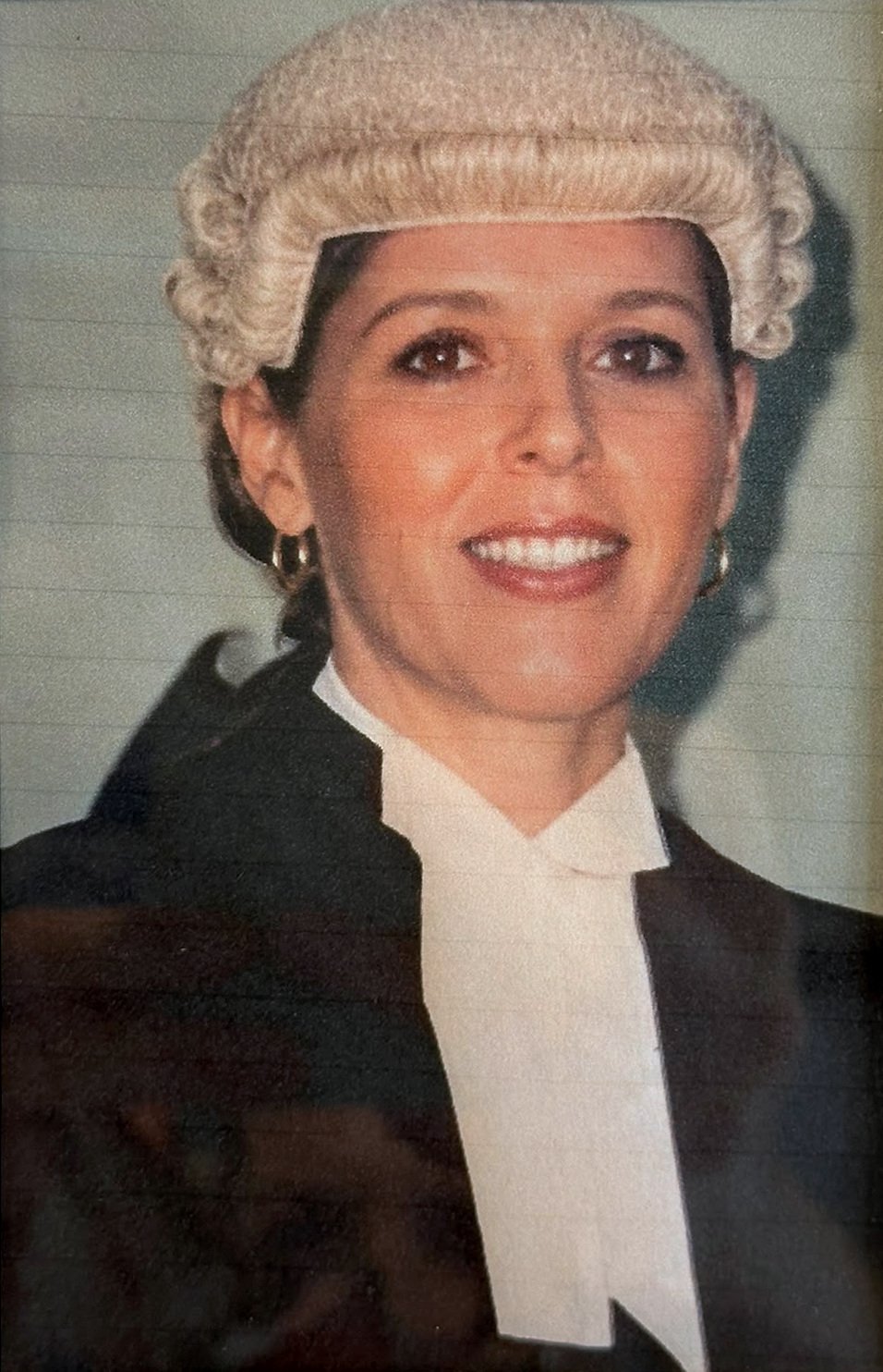 A young Rhonda L.C. Hull in barrister's wig and robes, smiling in a formal portrait