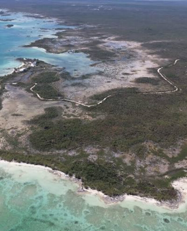 Aerial view of Witch Point, Abaco, showing white-sand shoreline, a winding creek and undeveloped waterfront land